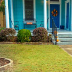 Color photograph of blue house with Orange accents in Dunbar historic neighborhood in Little Rock, Arkansas