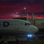 Color photograph of airplane at gate at Cincinnati airport getting ready for red eye flight to somewhere.