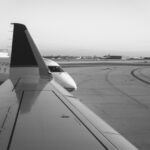 Black and white photograph of 2 airplanes parked on the runway awaiting gates at Chicago's O'Hare airport