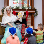color photograph of Arkansas Drag Queen Vanessa Rayne reading Prince and Knight to children in Little Rock Arkansas