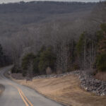 Color photograph of road descending into valley at lake fort smith Arkansas state park
